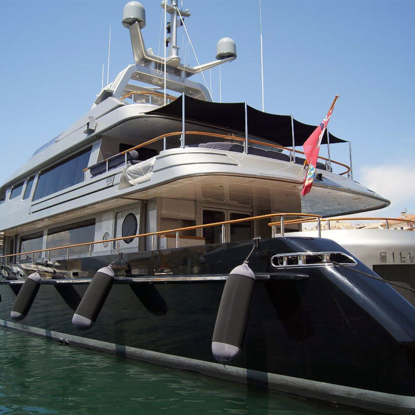 Fendertex textile fenders in grey protecting the hull of a large superyacht moored in a Mediterranean marina