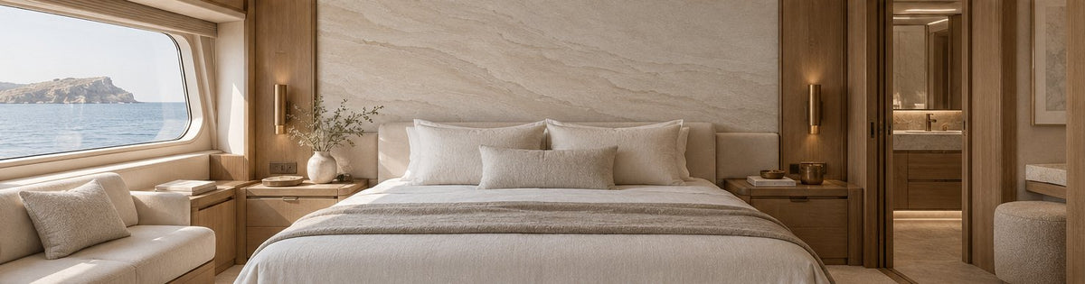 Design concept: a restful yacht suite with Calcaire limestone-strata wallcovering behind the bed, pale timber and ivory textiles